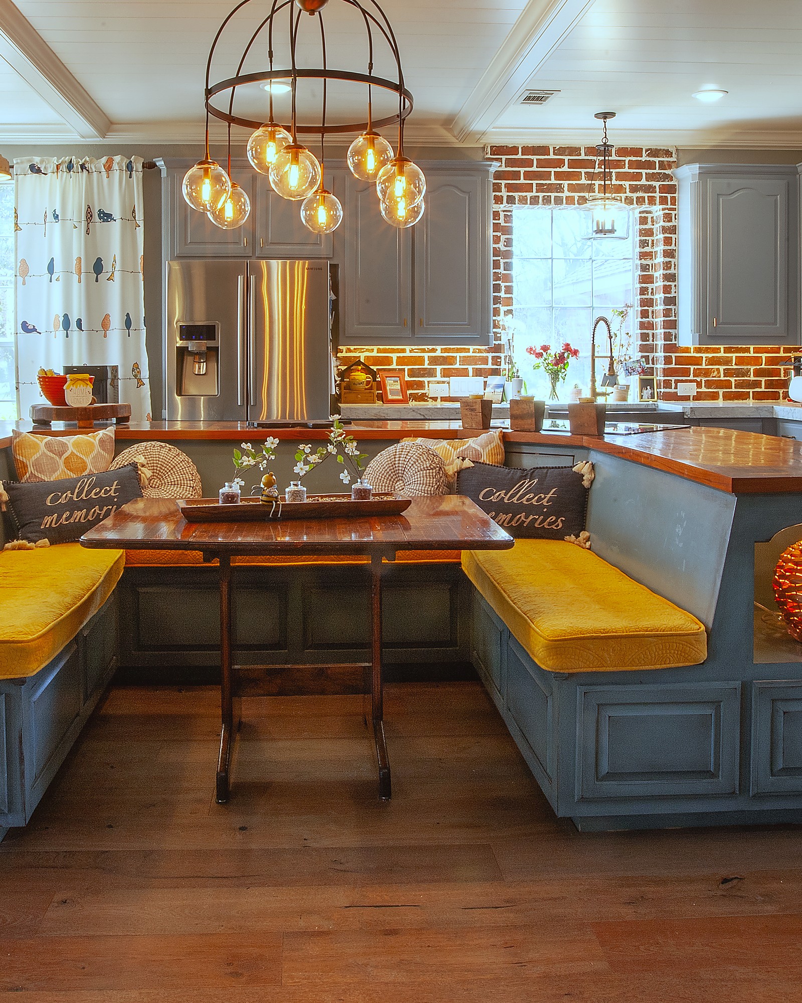 Built-in banquette dining with brick backsplash