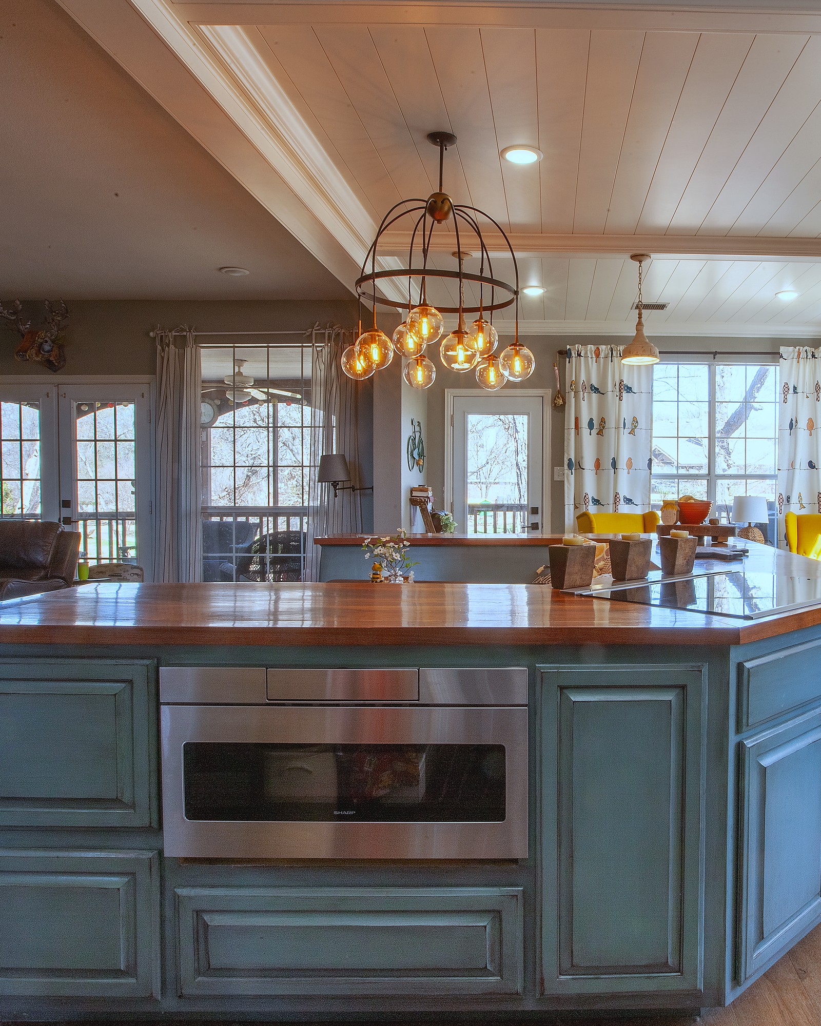 Open-concept kitchen island with chandelier